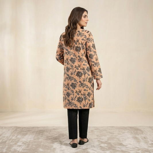 Woman wearing a floral patterned coat against a neutral background