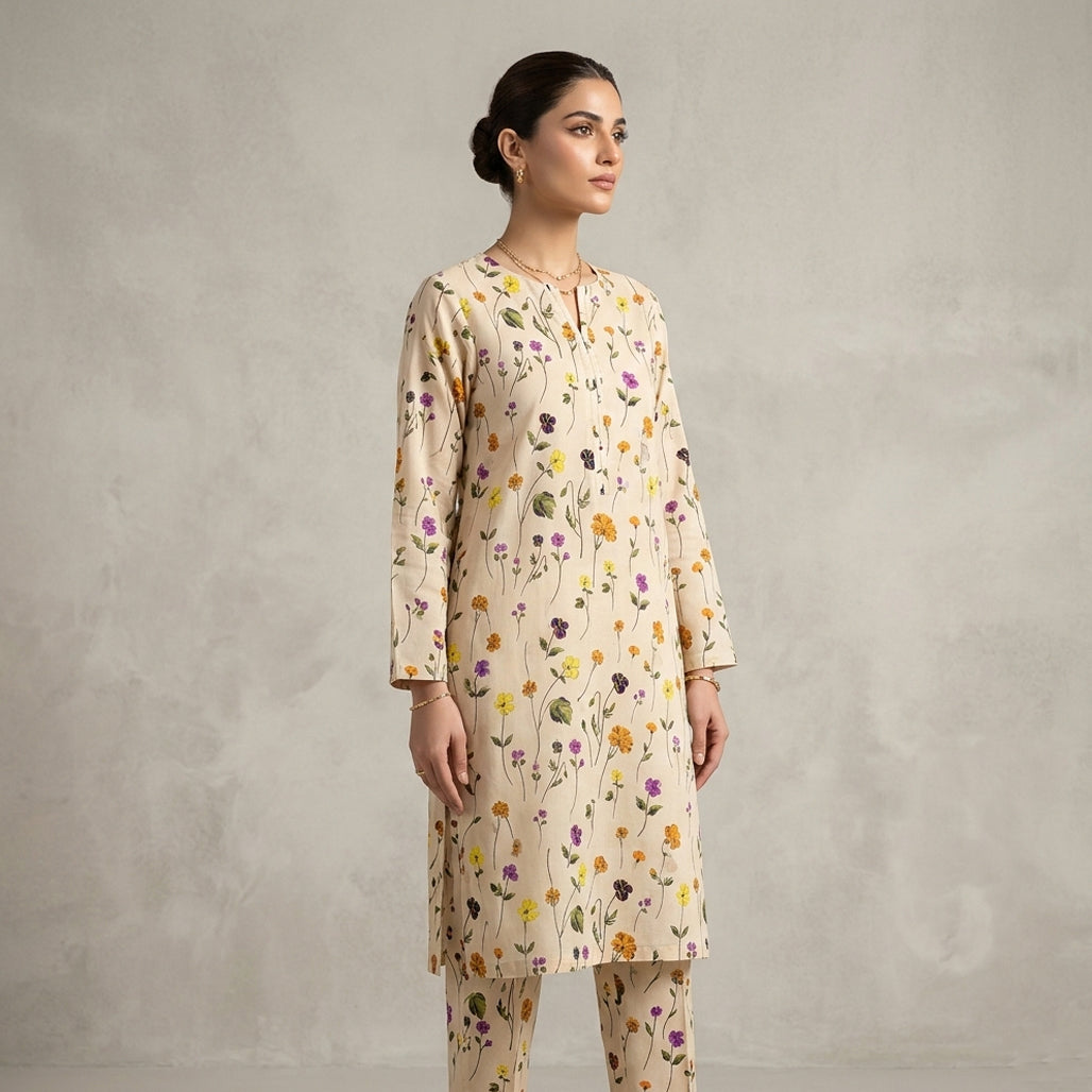 Woman wearing a floral kurta with a plain background