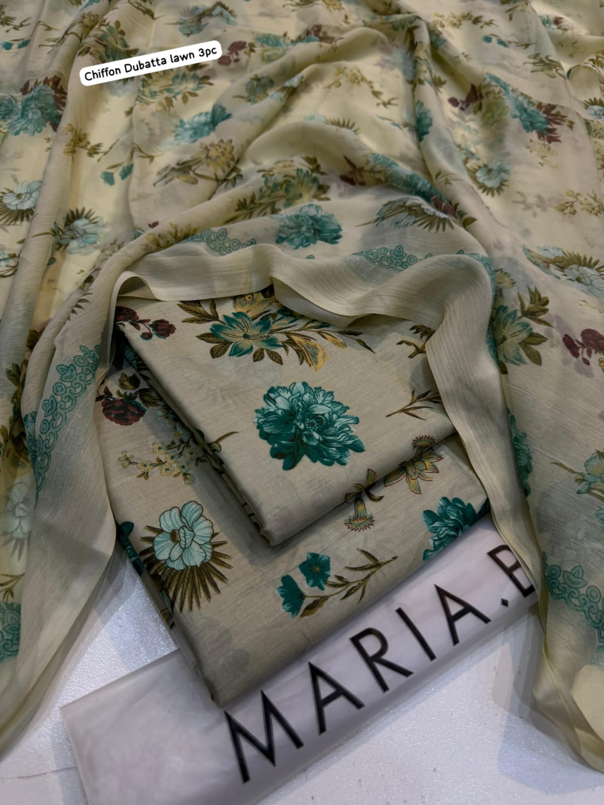 Floral fabric with 'Maria' branding on a white surface