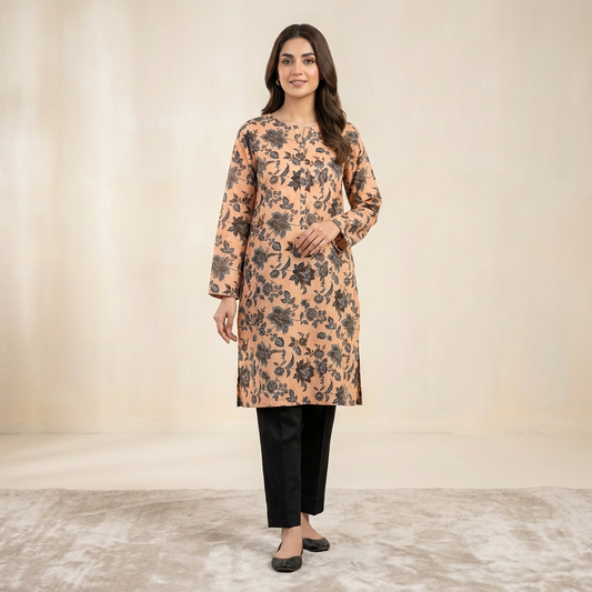 Woman wearing a floral patterned kurta with black pants on a plain background