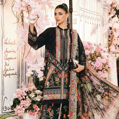Woman in a floral and black embroidered outfit with a decorative background