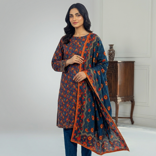 Woman wearing a blue and orange traditional outfit with a matching dupatta in a room.