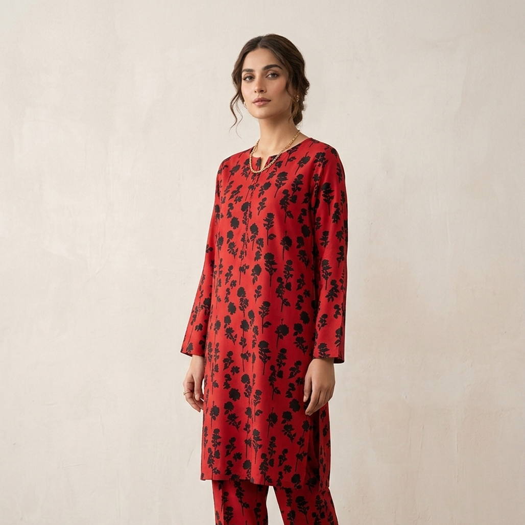 Woman wearing a red floral dress against a beige background