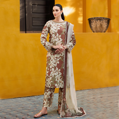 Woman in a floral outfit standing against a yellow wall.