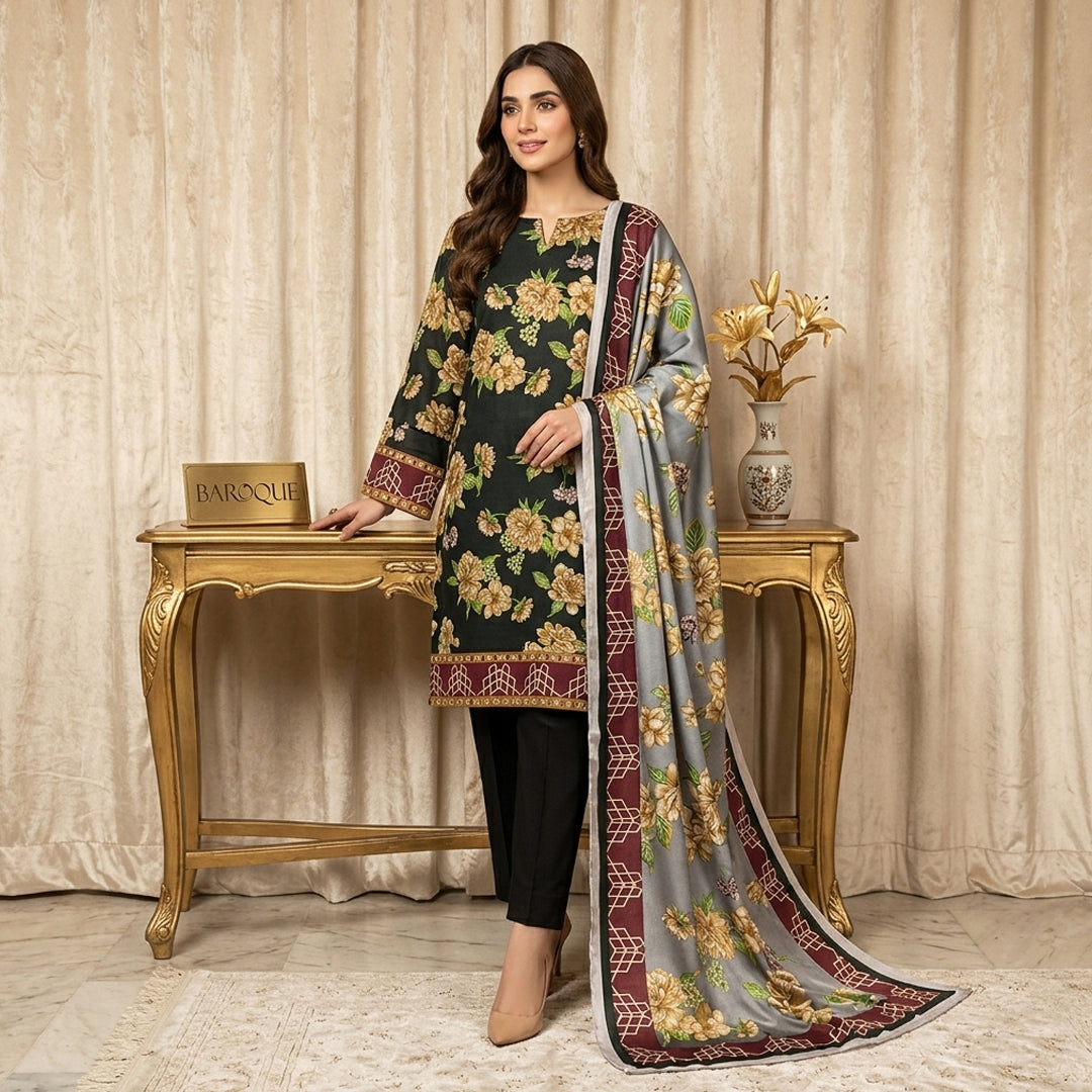 Woman in floral dress and dupatta standing next to a decorative table with a vase.