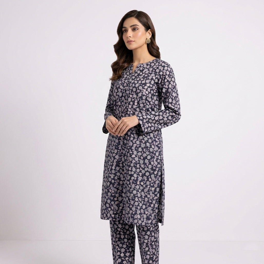 Woman wearing a floral kurta with pants on a white background