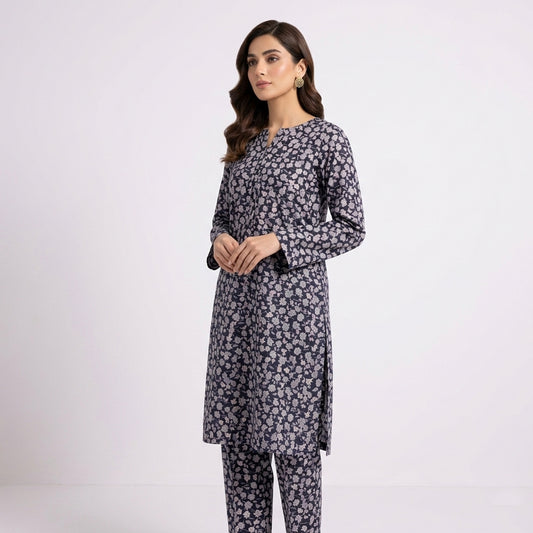 Woman wearing a floral kurta with pants on a white background