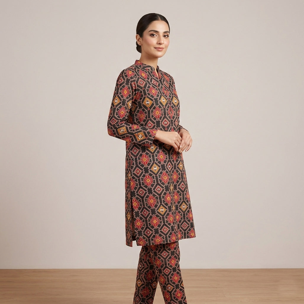 Woman wearing a patterned outfit against a plain background
