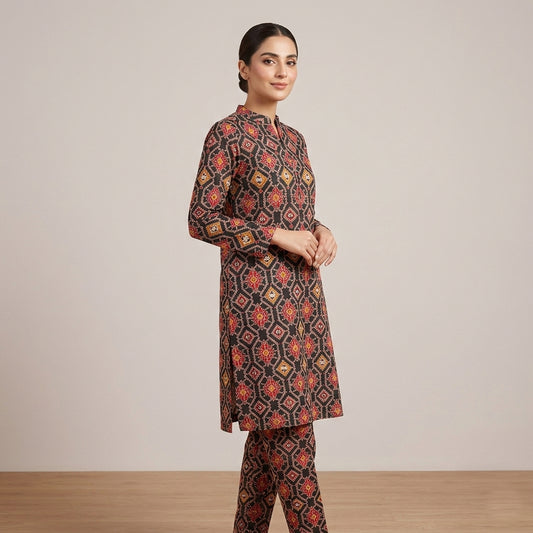 Woman wearing a patterned outfit against a plain background
