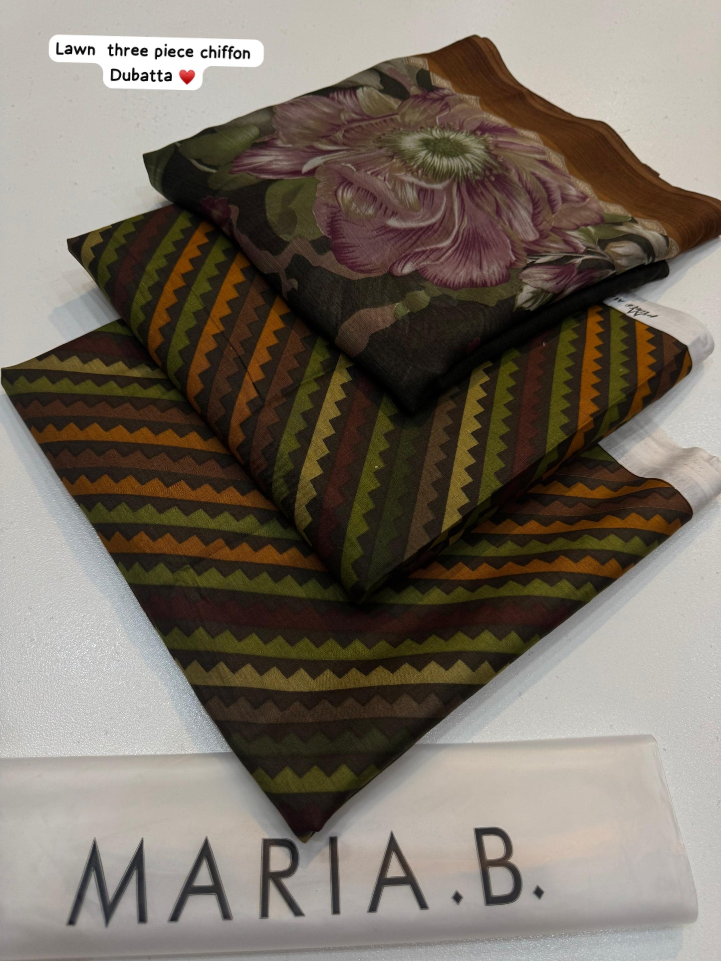 Two patterned scarves with a brand name label on a white background