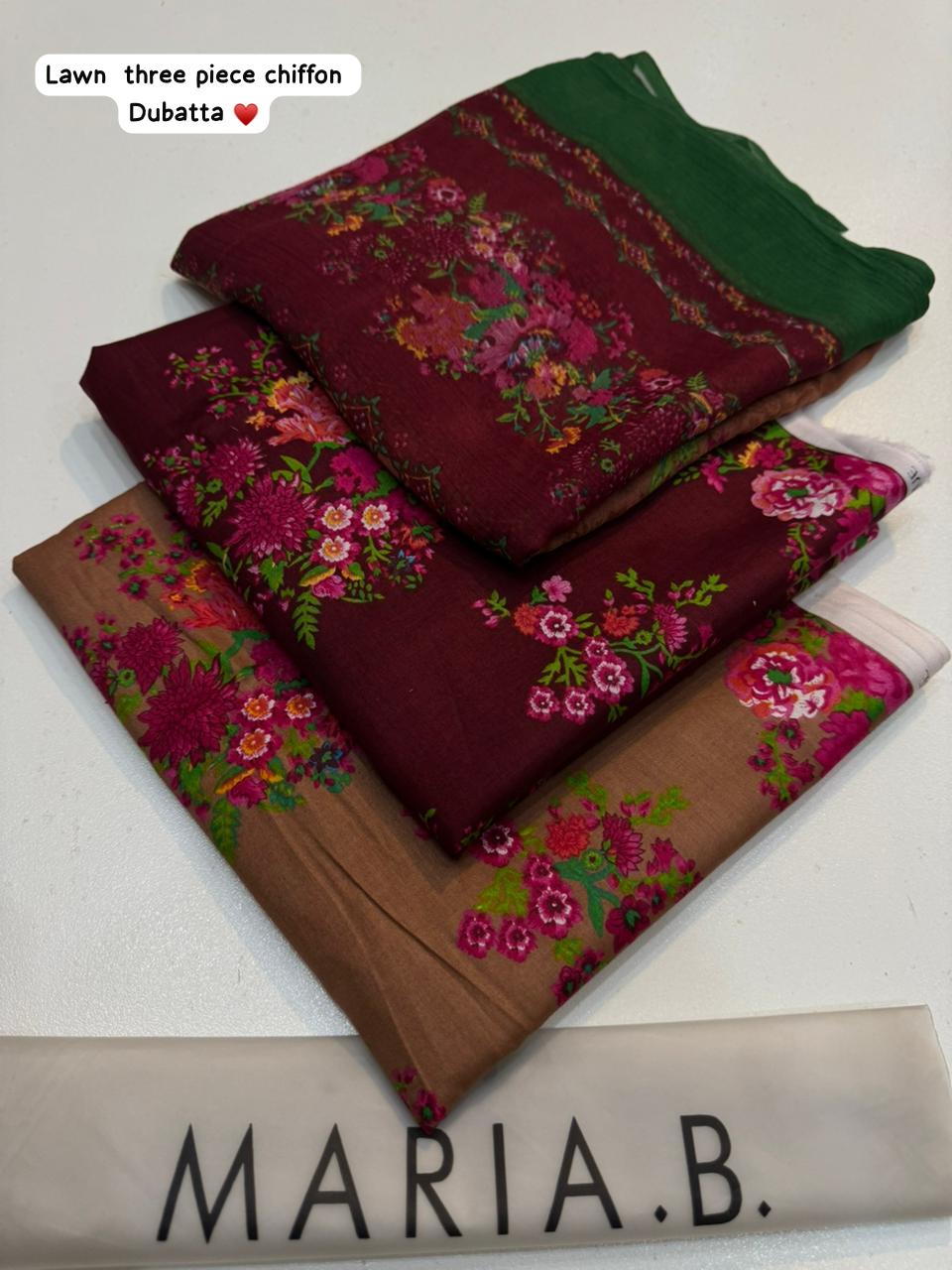 Three folded fabric pieces with floral patterns on a white background, branded 'Maria B'.