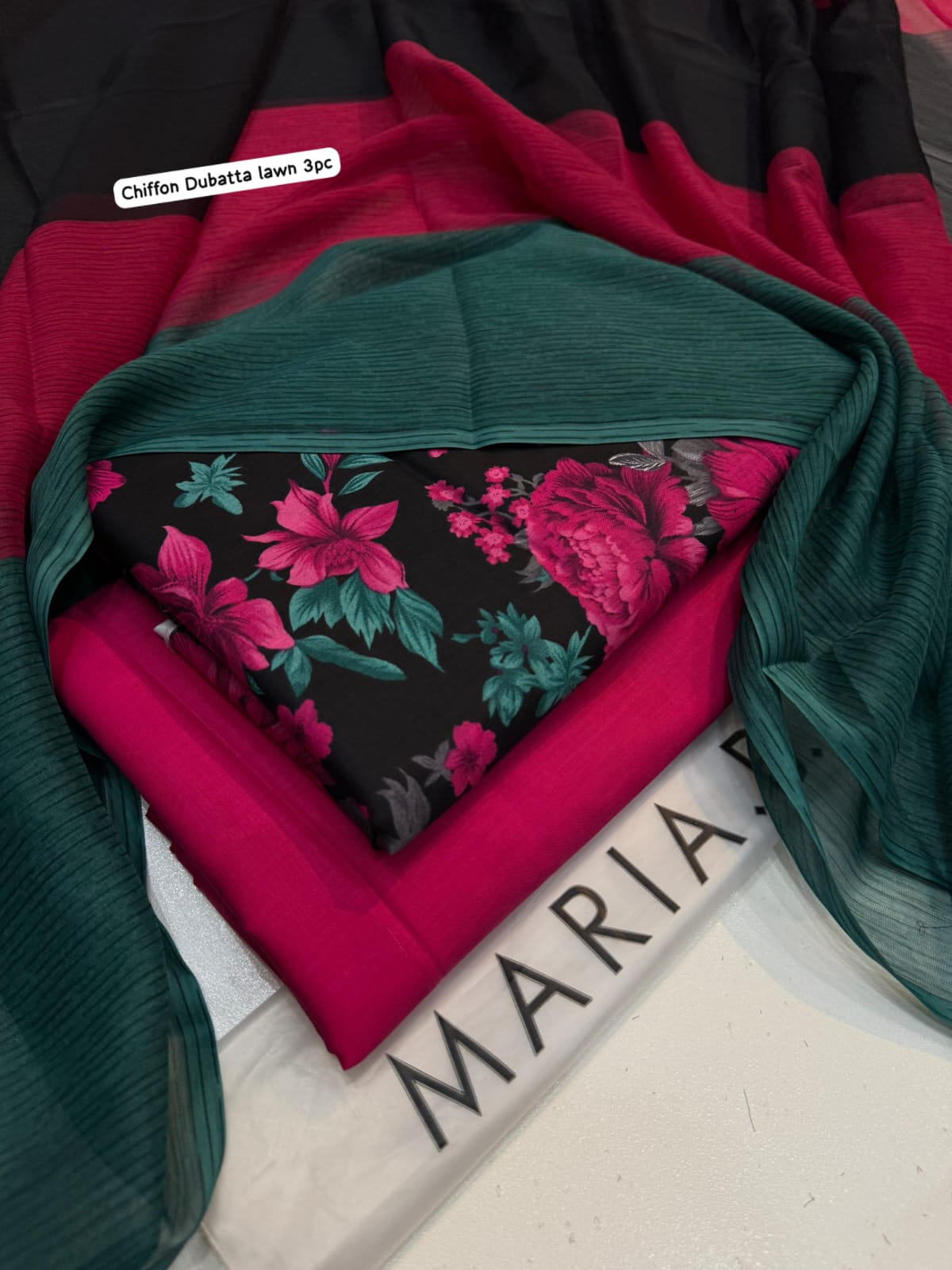 Stack of fabric pieces with floral pattern on a white surface