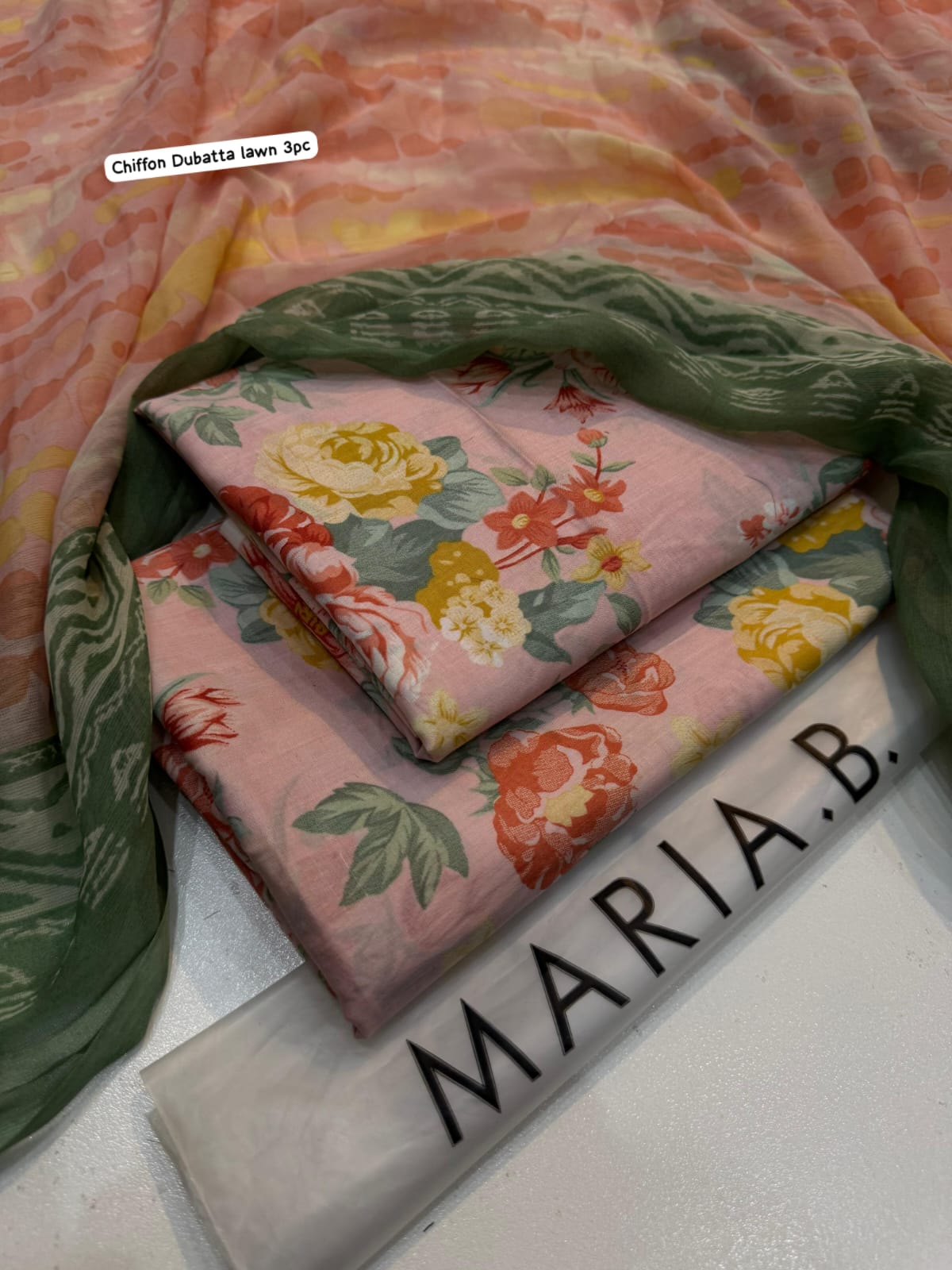Floral fabric with green border on a white surface, labeled 'Maria B'.