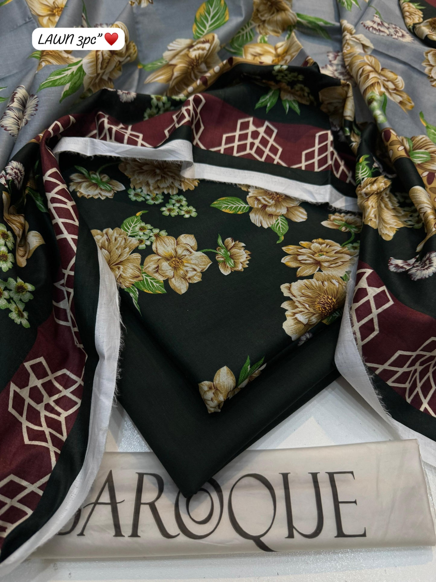 Floral-patterned fabric with maroon and gold accents on a white surface with 'Baroque' branding.