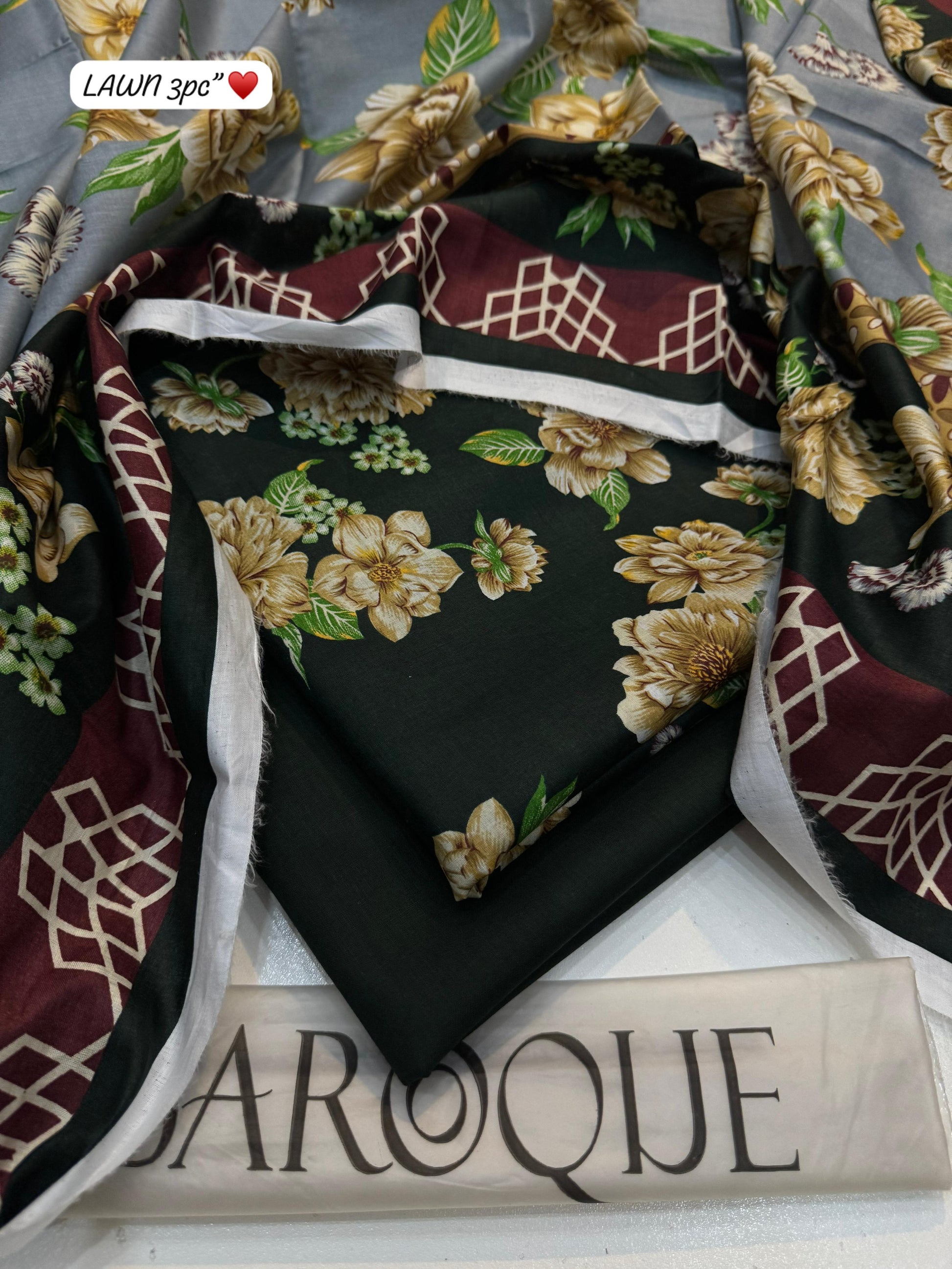 Floral-patterned fabric with maroon and gold accents on a white surface with 'Baroque' branding.