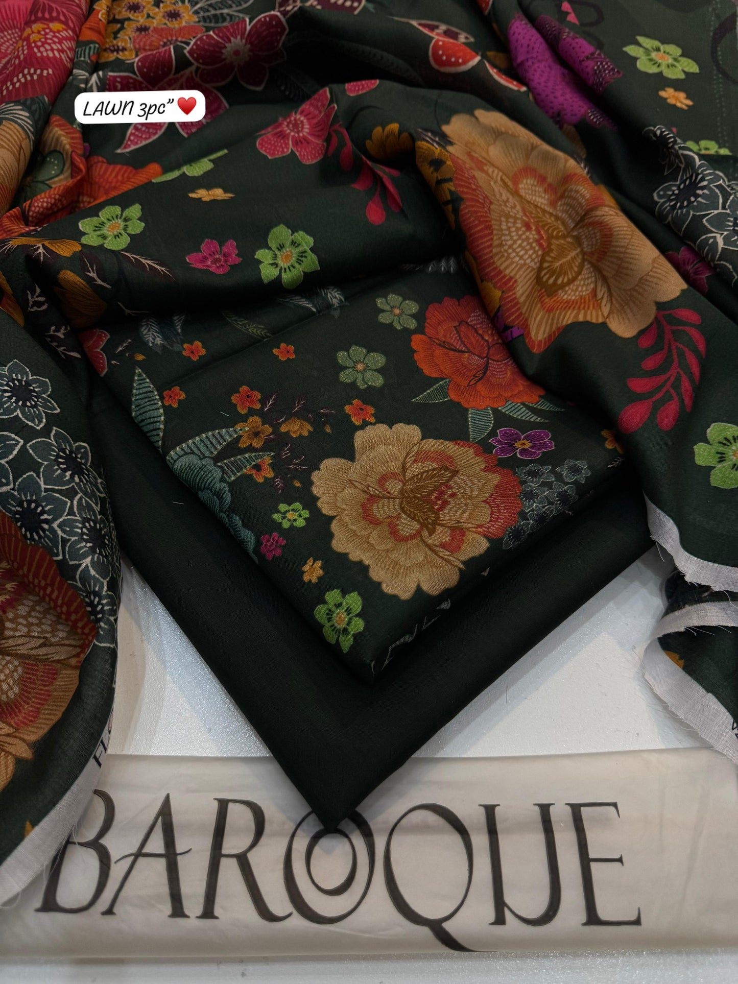 Embroidered fabrics with floral patterns on a 'Baroque' branded surface